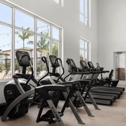 fitness center with open spaces and bright lighting through the windows