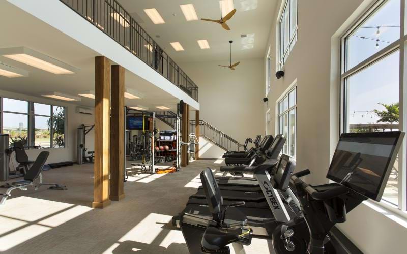 a room with treadmills and windows