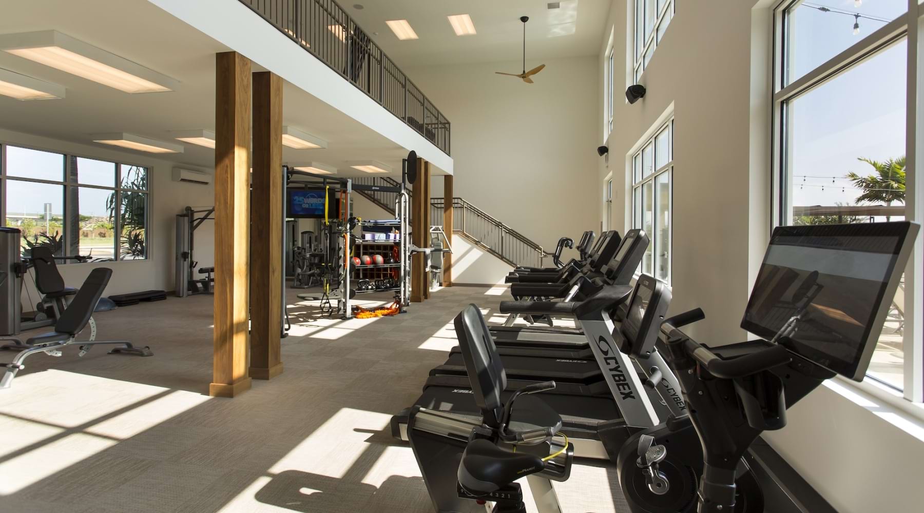 fitness center with rows of treadmills and modern style flooring