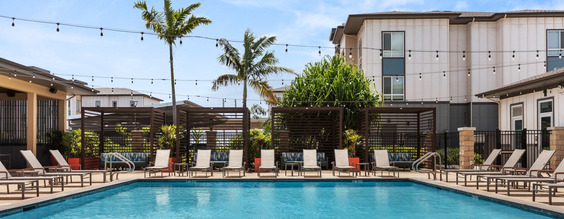a swimming pool with lounge chairs