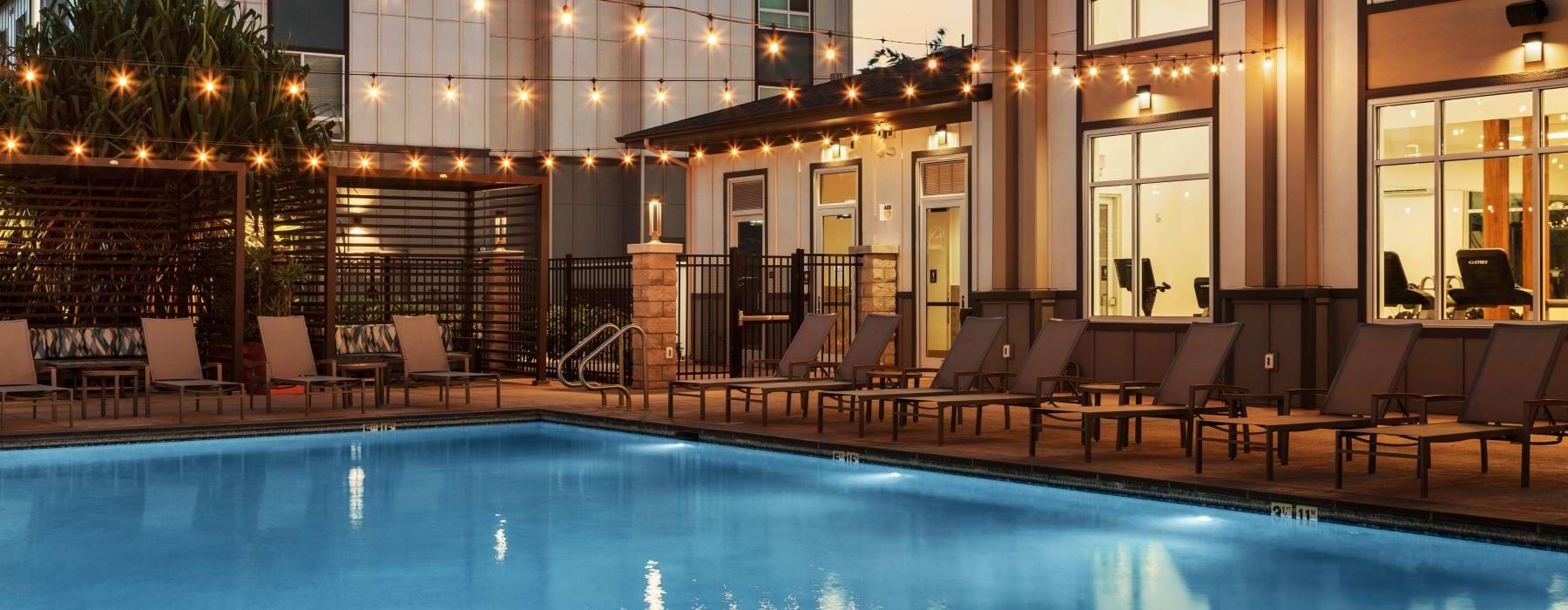 a swimming pool with chairs around it